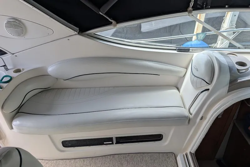 Slide: The Image of Interior seating of a 2002 Maxum 2700 SCR boat, featuring white leather upholstery. - 18