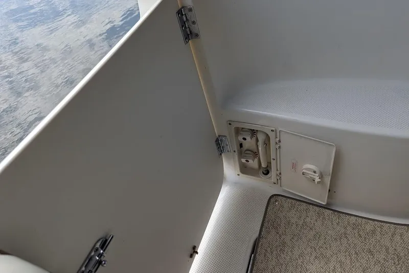 Slide: The Image of Interior view of a 2002 Maxum 2700 SCR boat showing a compartment and hinges. - 19