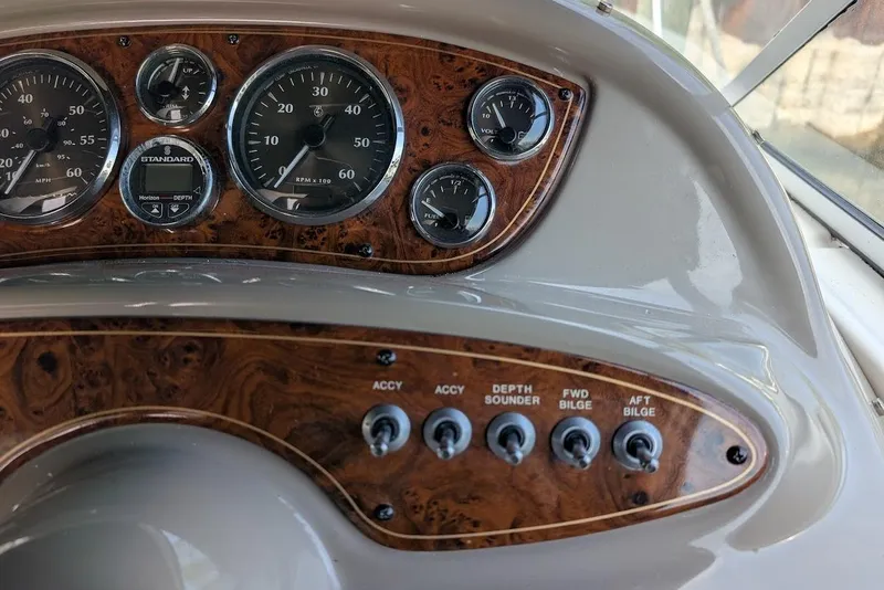 Slide: The Image of Dashboard of 2002 Maxum 2700 SCR boat with gauges and switches. - 23