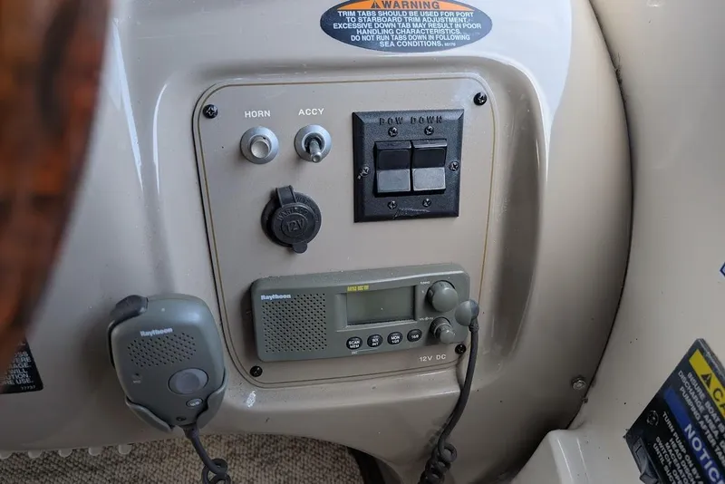 Slide: The Image of Control panel of a 2002 Maxum 2700 SCR boat with radio and switches. - 24