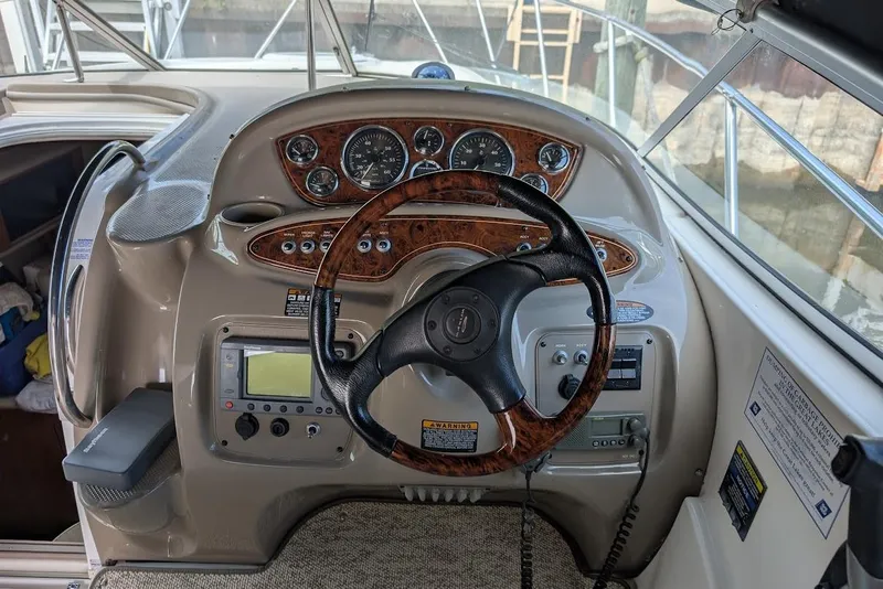 Slide: The Image of 2002 Maxum 2700 SCR boat dashboard with steering wheel and instrument panel. - 25