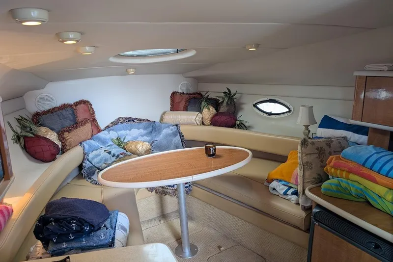 Slide: The Image of Interior of 2002 Maxum 2700 SCR boat with cozy seating and colorful cushions. - 27