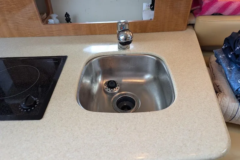 Slide: The Image of Kitchen sink and stovetop in 2002 Maxum 2700 SCR boat interior. - 32