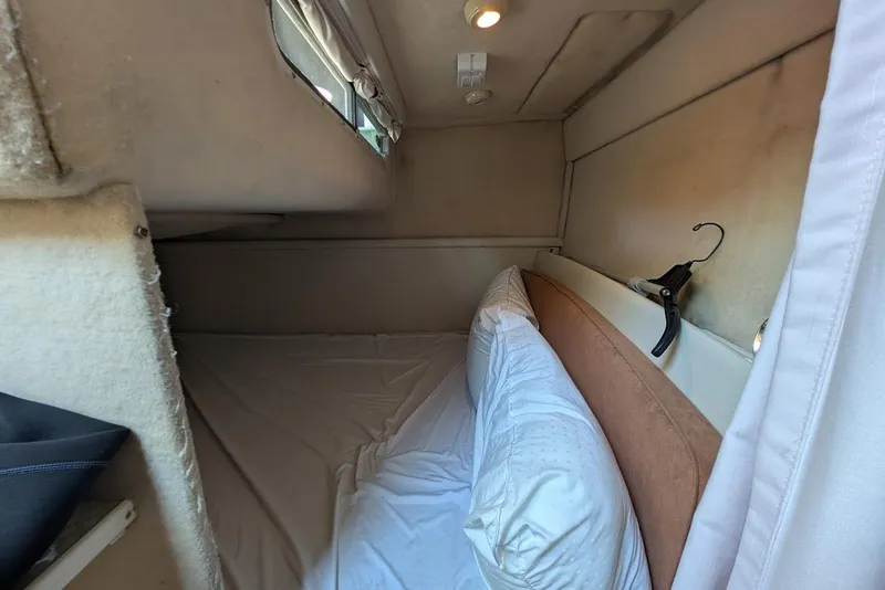 Slide: The Image of Cozy cabin interior of 2002 Maxum 2700 SCR boat with bed and window. - 34