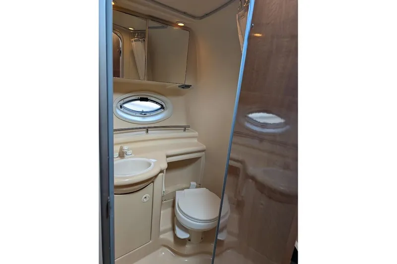 Slide: The Image of Compact bathroom in 2002 Maxum 2700 SCR boat with sink, toilet, and mirror. - 36