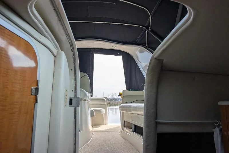 Slide: The Image of Interior view of 2002 Maxum 2700 SCR boat, featuring seating and cabin entrance. - 40