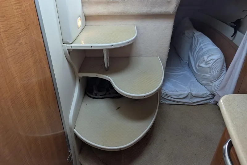 Slide: The Image of Interior of 2002 Maxum 2700 SCR boat with curved steps and cozy sleeping area. - 41