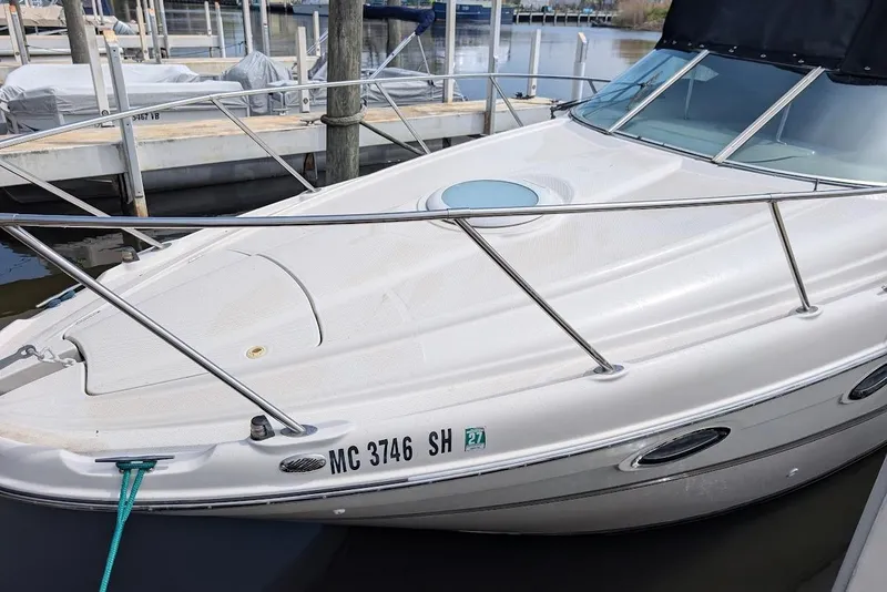 Slide: The Image of 2002 Maxum 2700 SCR boat docked at marina, featuring sleek design and white exterior. - 6