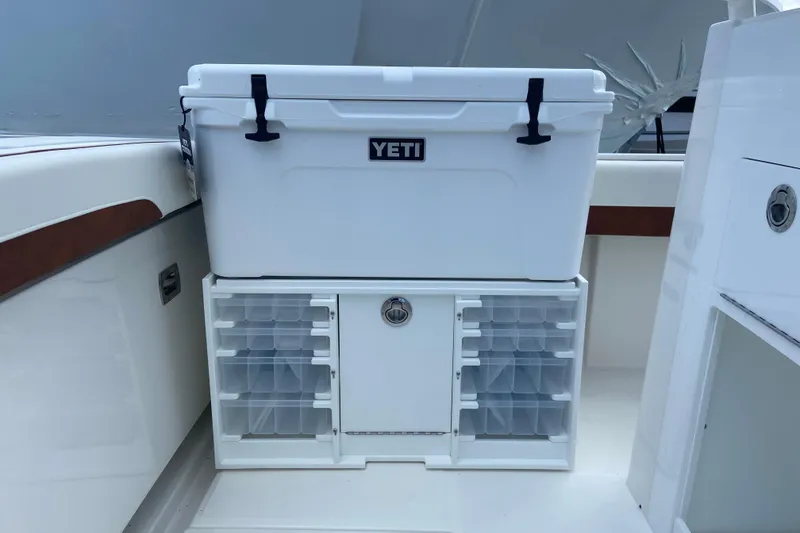 Slide: The Image of YETI cooler on 2026 Regulator 28 boat with organized storage compartments. - 10