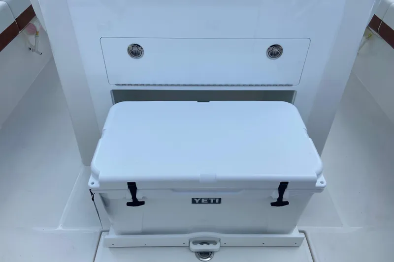 Slide: The Image of YETI cooler on 2026 Regulator 28 boat, featuring sleek white design and secure latches. - 11