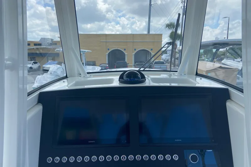 Slide: The Image of 2026 Regulator 28 boat dashboard with dual Garmin displays and control panel. - 14