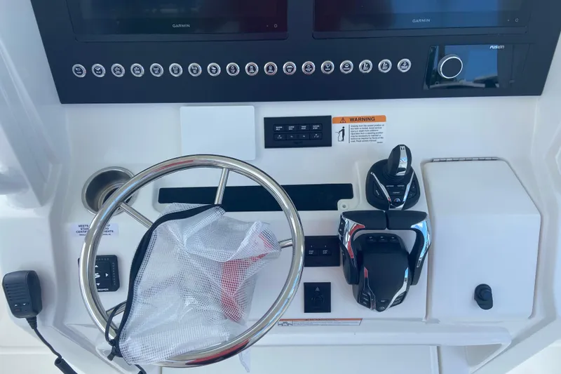 Slide: The Image of 2026 Regulator 28 boat dashboard with steering wheel and control panel. - 15