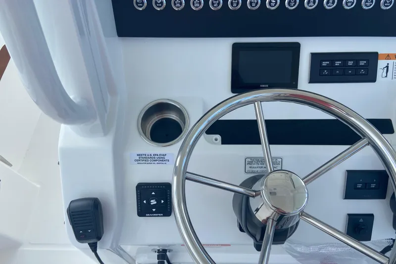 Slide: The Image of Control panel of a 2026 Regulator 28 boat with steering wheel and electronic displays. - 17