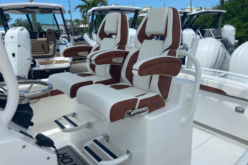 Slide: The Image of Luxury seating on a 2026 Regulator 28 boat, featuring plush white and brown upholstery. - 20
