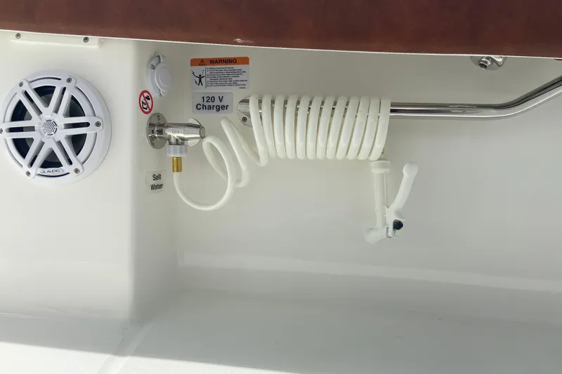 Slide: The Image of Boat interior with speaker, coiled hose, and 120V charger on Regulator 28, 2026 model. - 21