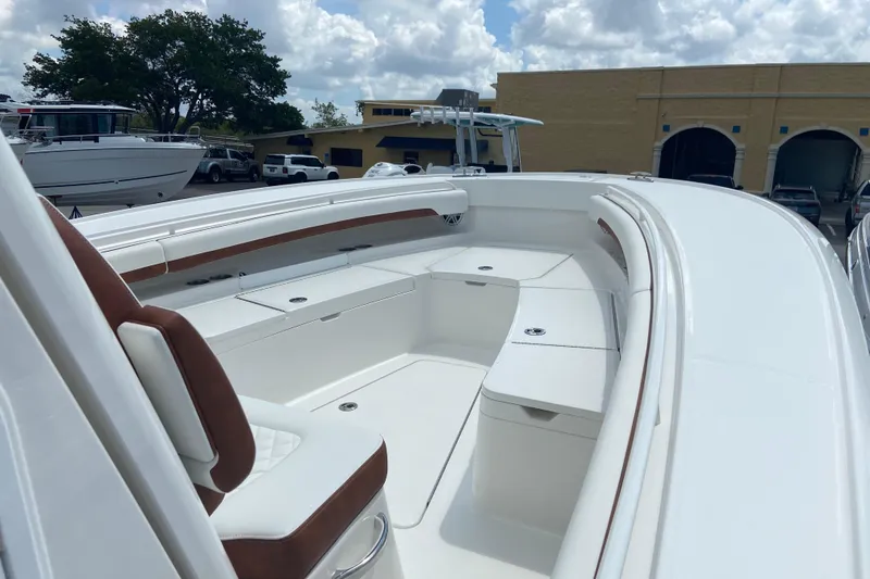 Slide: The Image of 2026 Regulator 28 boat with spacious seating and sleek design under a cloudy sky. - 24