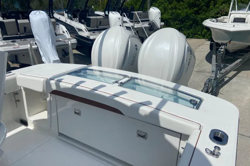 Slide: The Image of 2026 Regulator 28 boat with dual Yamaha outboard engines, docked in a marina. - 3