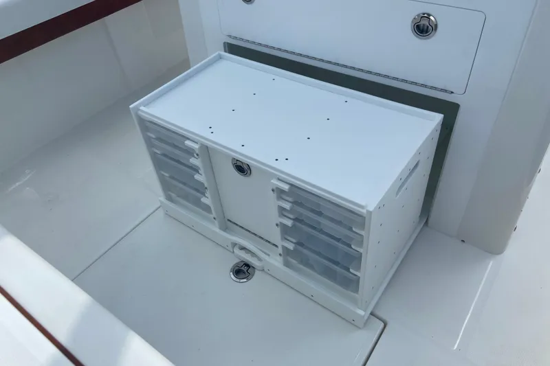Slide: The Image of Storage compartment on a 2026 Regulator 28 boat, featuring multiple drawers and secure locks. - 9