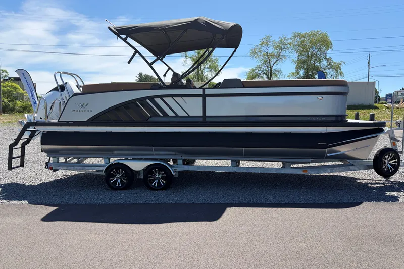 The Image of 2026 Whisper V23 RLS pontoon boat on trailer, featuring sleek design and canopy. - 0