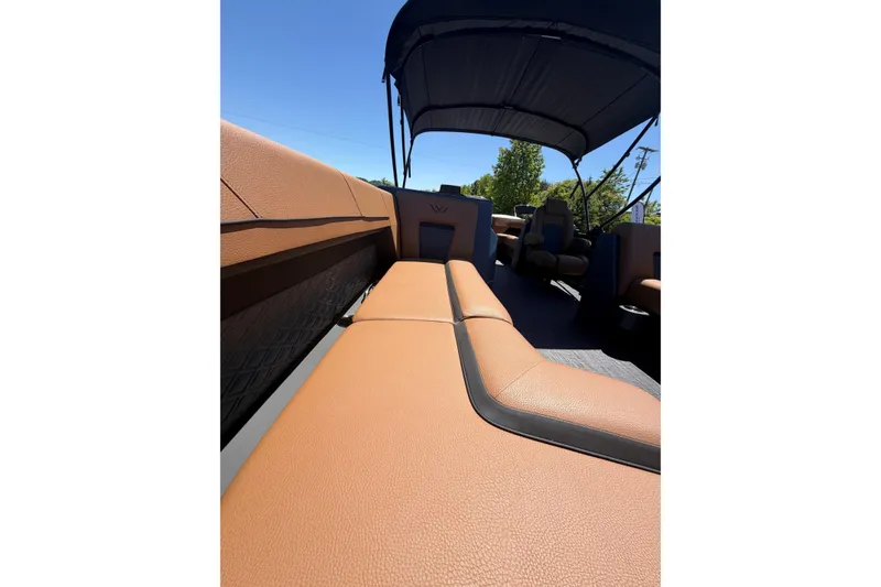 Slide: The Image of Luxurious interior of 2026 Whisper V23 RLS boat with tan leather seating and canopy. - 11