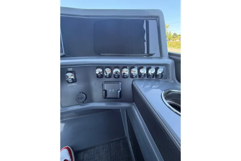 Slide: The Image of Control panel of 2026 Whisper V23 RLS boat with switches and cup holder. - 16