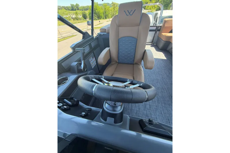 Slide: The Image of Captain's chair and steering wheel of 2026 Whisper V23 RLS boat, featuring modern design. - 17