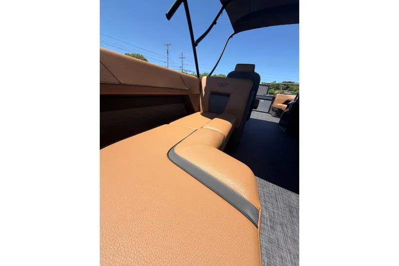 Slide: The Image of Luxurious tan leather seating in 2026 Whisper V23 RLS boat under clear blue sky. - 19
