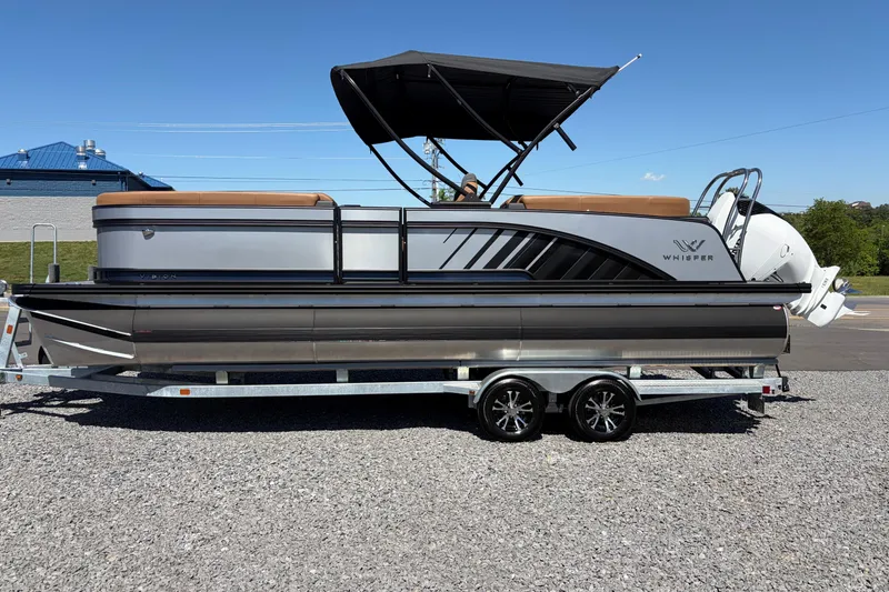Slide: The Image of 2026 Whisper V23 RLS pontoon boat on trailer, featuring sleek design and canopy. - 2