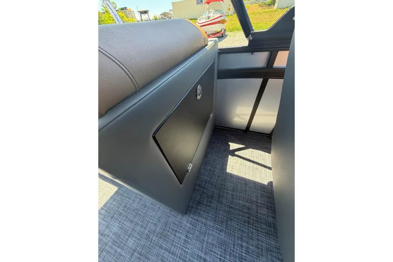Slide: The Image of Interior view of 2026 Whisper V23 RLS boat, featuring sleek seating and storage compartment. - 21