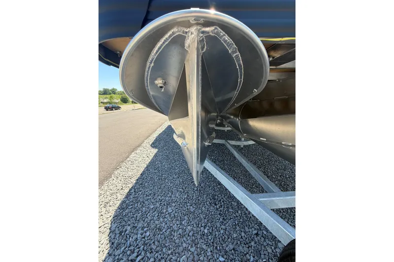 Slide: The Image of Close-up of 2026 Whisper V23 RLS boat hull on trailer, parked on gravel. - 28