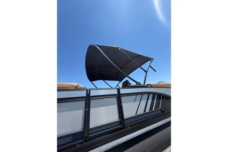 Slide: The Image of 2026 Whisper V23 RLS boat with canopy against clear blue sky. - 3