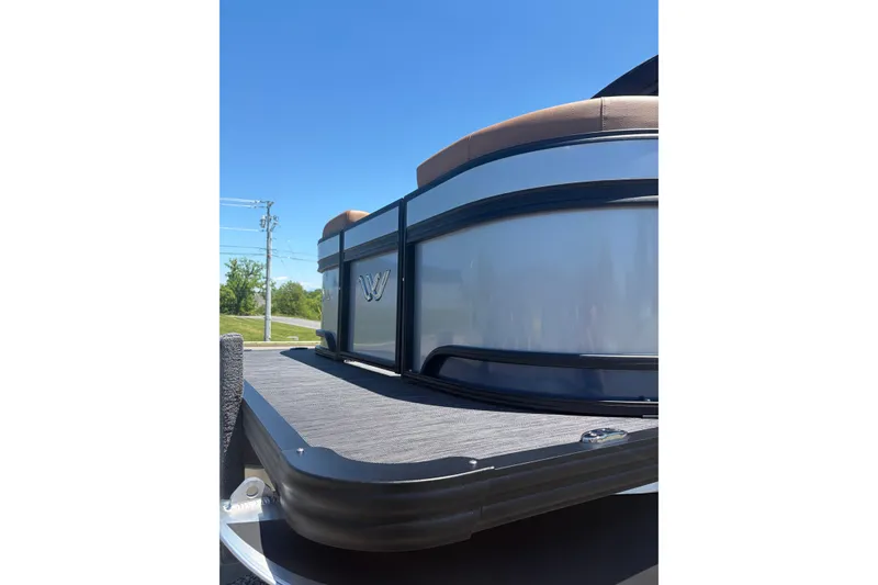 Slide: The Image of 2026 Whisper V23 RLS pontoon boat, sleek design, sunny day, outdoor setting. - 5