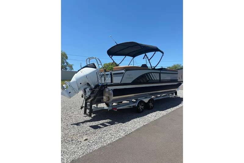 Slide: The Image of 2026 Whisper V23 RLS boat on trailer, featuring sleek design and powerful outboard motor. - 6