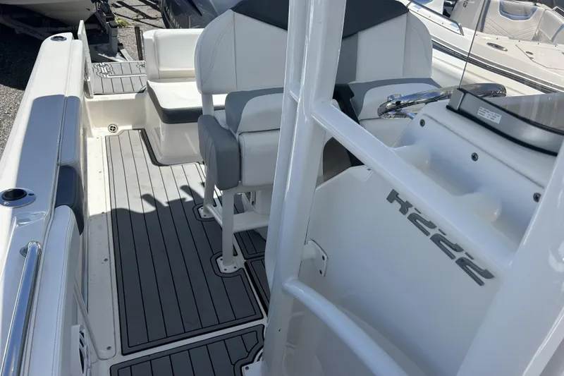 Slide: The Image of 2021 Robalo R222 Explorer boat interior with seating and steering console. - 15