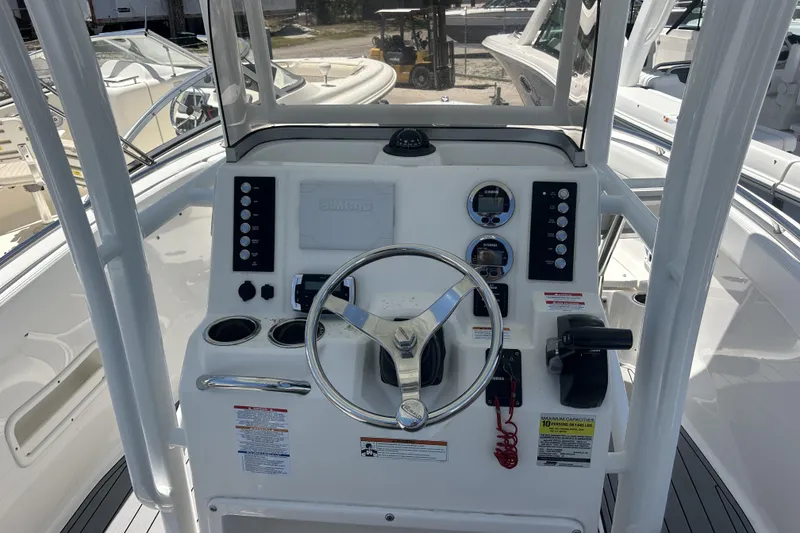 Slide: The Image of 2021 Robalo R222 Explorer boat helm with steering wheel and control panel. - 16