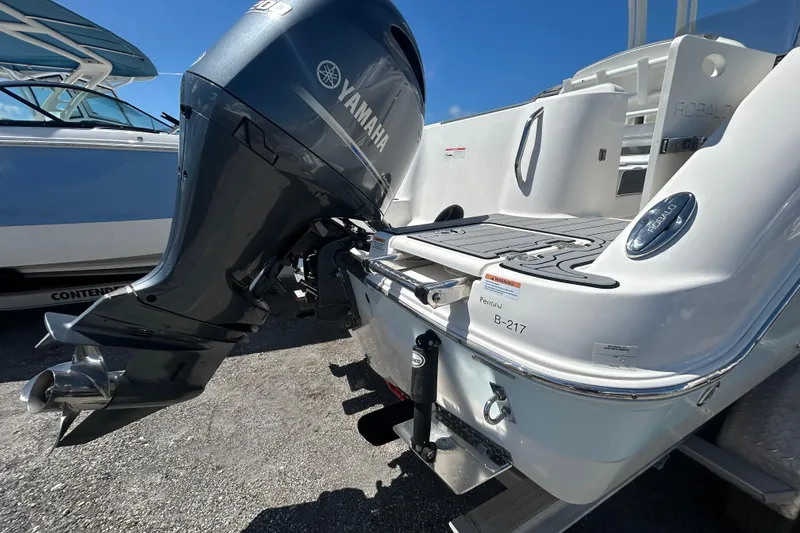 Slide: The Image of 2021 Robalo R222 Explorer boat with Yamaha outboard motor, docked on a sunny day. - 3