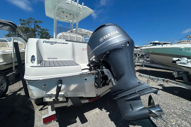 Slide: The Image of 2021 Robalo R222 Explorer boat with Yamaha outboard motor, parked outdoors. - 4