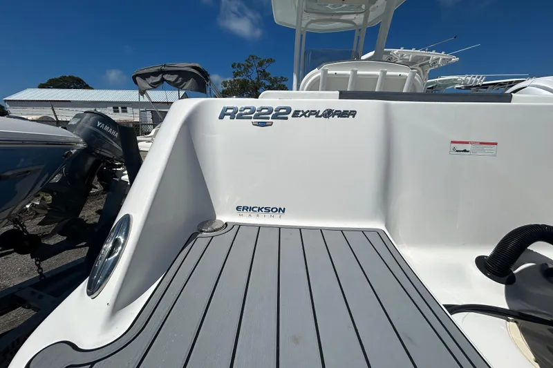 Slide: The Image of 2021 Robalo R222 Explorer boat deck with Yamaha engine in marina setting. - 5