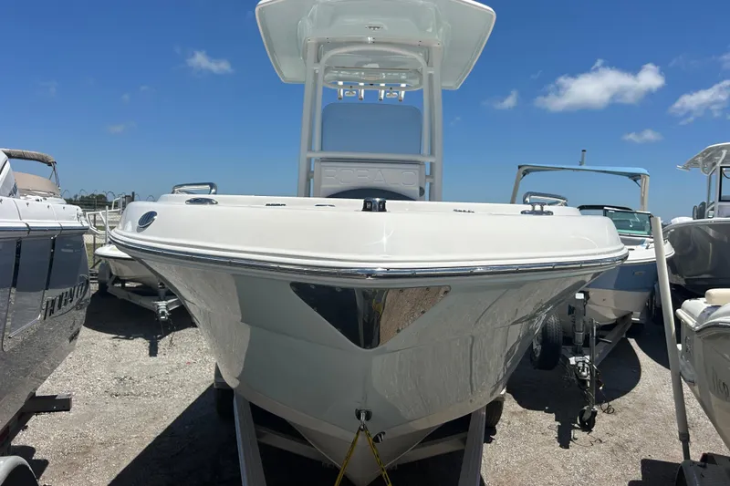 Slide: The Image of 2021 Robalo R222 Explorer boat displayed outdoors under clear blue sky. - 6