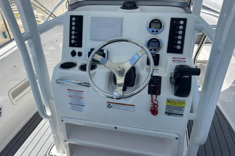 Slide: The Image of 2021 Robalo R222 Explorer boat dashboard with steering wheel and controls. - 9