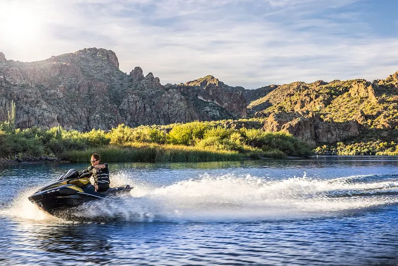 Slide: The Image of 2023 Kawasaki JET SKI ULTRA 160LX on a lake with mountain backdrop. - 13