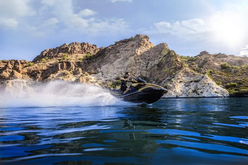 Slide: The Image of 2023 Kawasaki JET SKI ULTRA 160LX on a lake with rocky backdrop. - 19