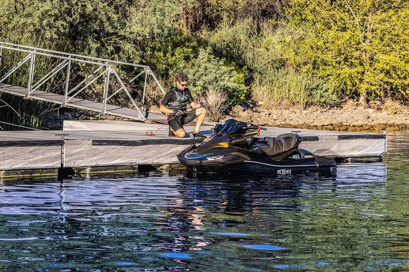 Slide: The Image of Man securing 2023 Kawasaki JET SKI ULTRA 160LX at dock. - 9
