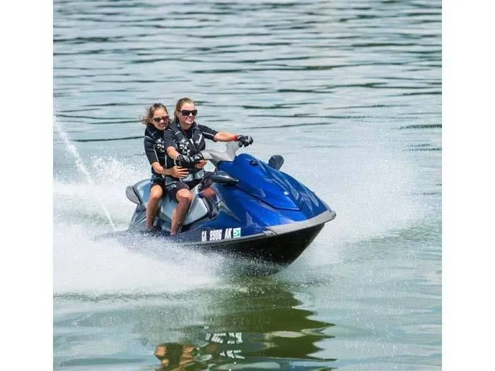 Slide: The Image of Two people riding 2014 Yamaha VX® Deluxe jet ski on water. - 4