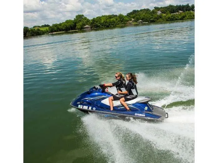 Slide: The Image of Two people riding 2014 Yamaha VX® Deluxe jet ski on a lake. - 6