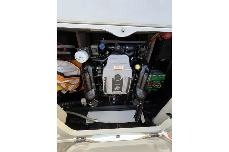 Slide: The Image of Engine compartment of a 2012 Stingray 235 LR boat, showcasing the motor and components. - 10