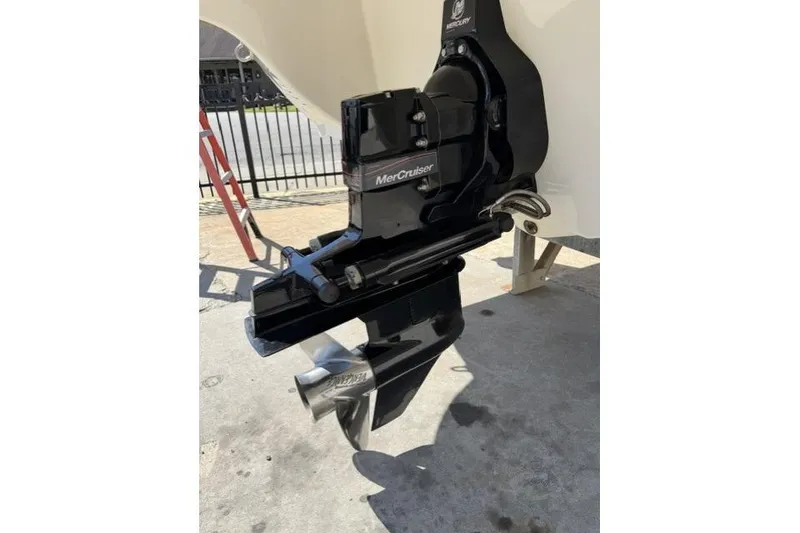 Slide: The Image of MerCruiser outdrive on a 2012 Stingray 235 LR boat, parked on concrete. - 11