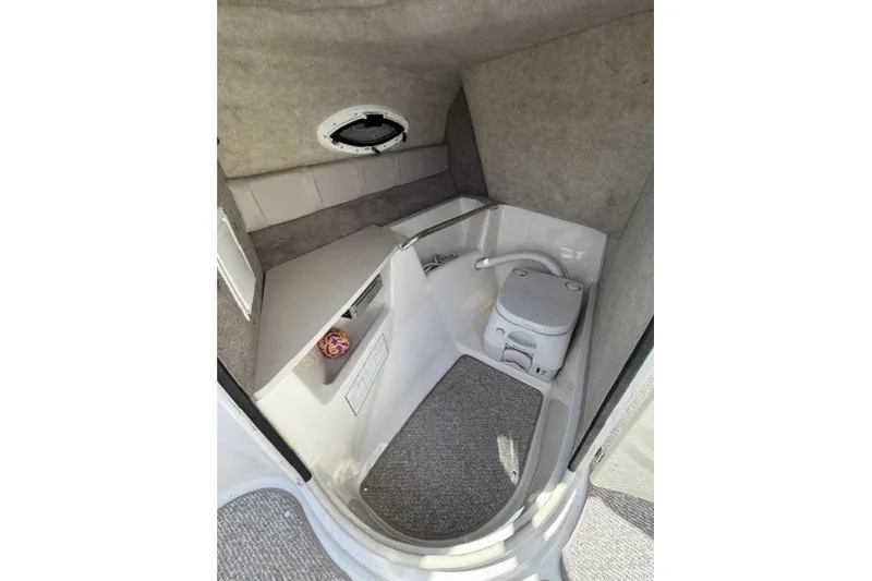 Slide: The Image of Interior cabin of 2012 Stingray 235 LR boat with compact toilet. - 12