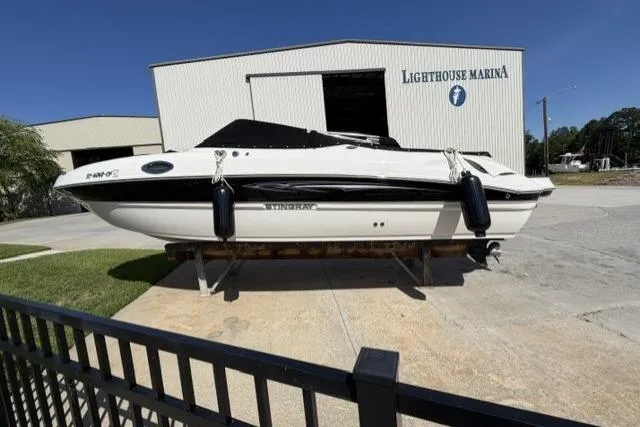 Slide: The Image of 2012 Stingray 235 LR boat at Lighthouse Marina, displayed on a trailer. - 15