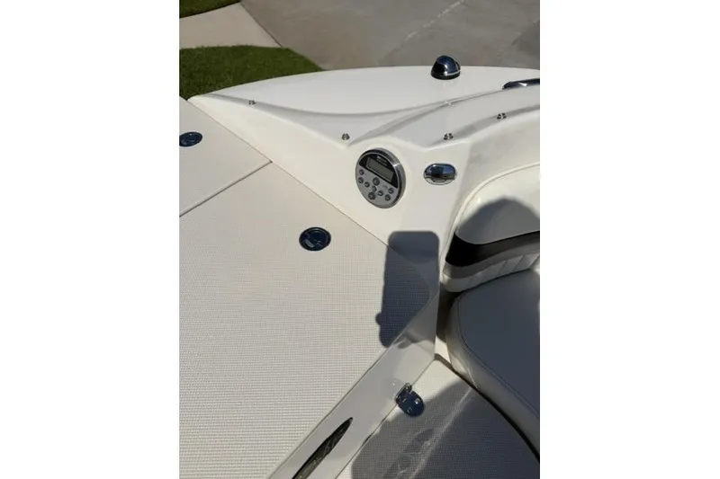 Slide: The Image of 2012 Stingray 235 LR boat interior with control panel and seating area. - 19